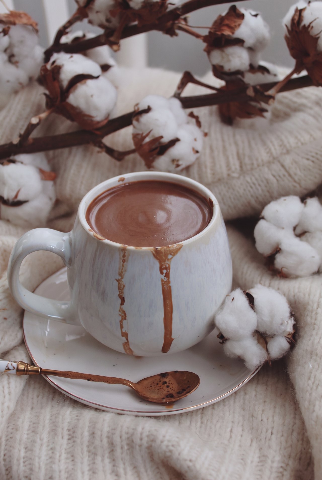 A cup of thick, creamy Italian hot chocolate on a saucer with a spoon